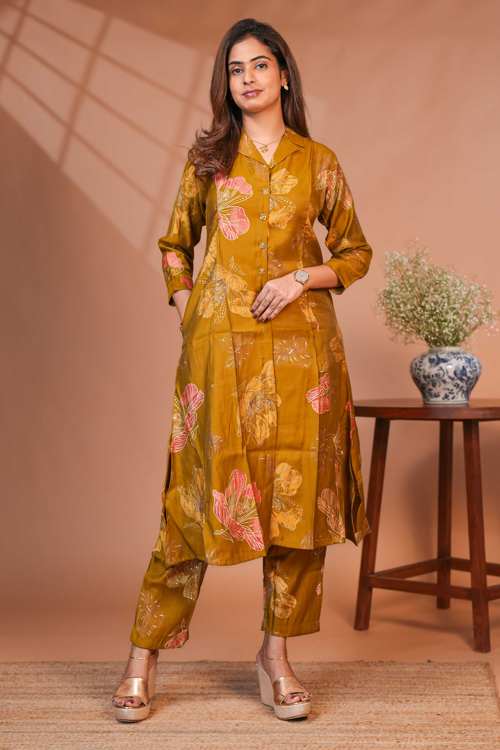 A-Line Cut Ensures a Flattering Fit That Transitions Leaf Clusters and Sunflower Patterns in Gold and Cream Kurti
