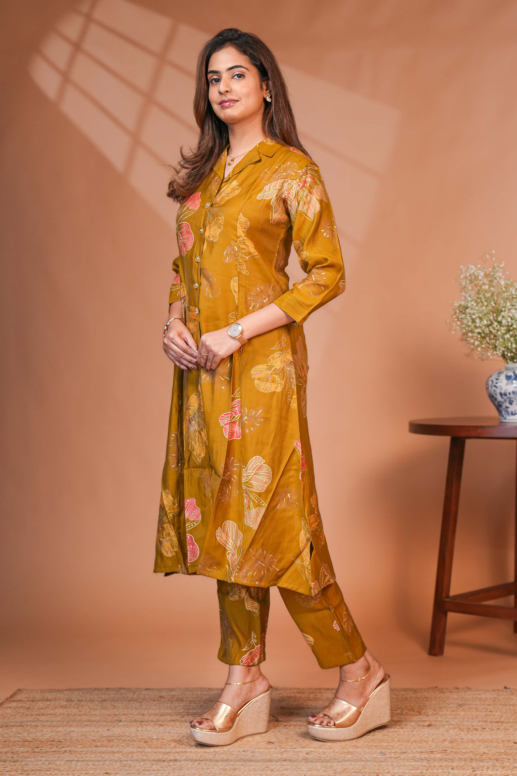 A-Line Cut Ensures a Flattering Fit That Transitions Leaf Clusters and Sunflower Patterns in Gold and Cream Kurti