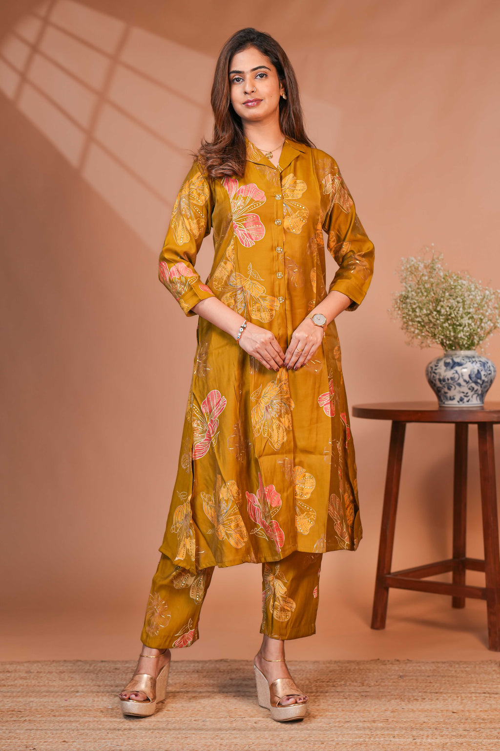 A-Line Cut Ensures a Flattering Fit That Transitions Leaf Clusters and Sunflower Patterns in Gold and Cream Kurti