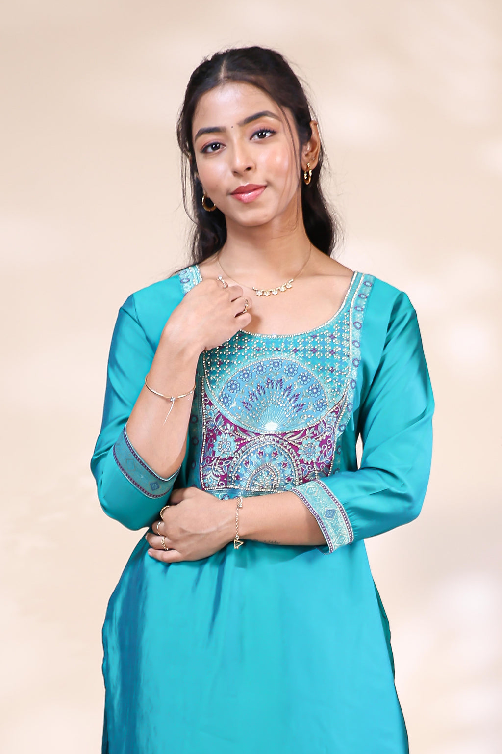 Close-up of embroidery on teal blue silk blend kurta set