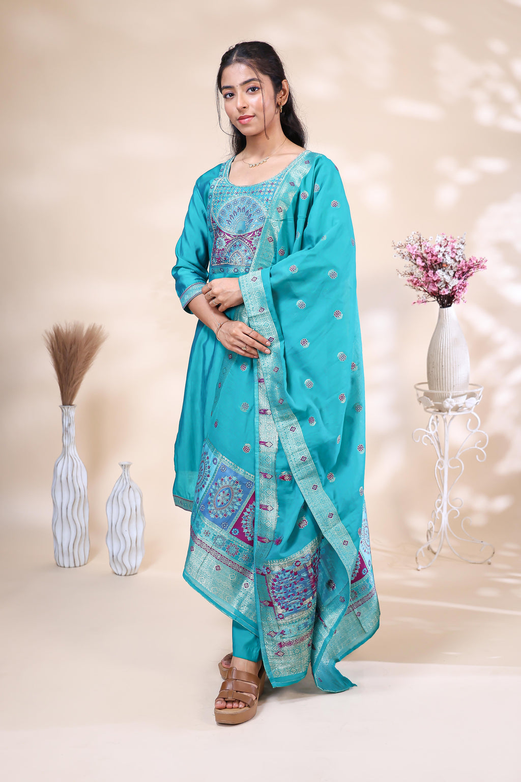 Front view of elegant teal blue embroidered three piece suit for women